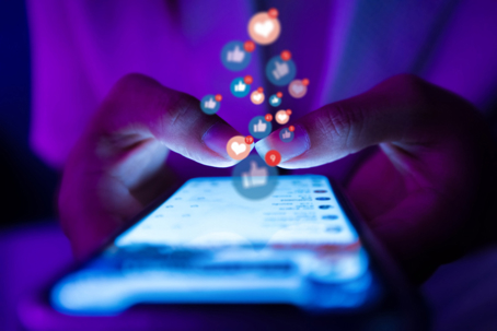 iphone being used by a young woman to go on social media apps